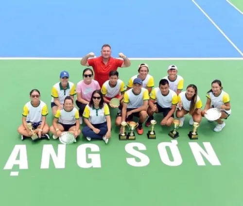 Marcel Petit with a Vietnamese junior team and their trophies